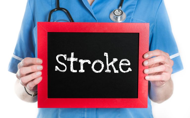 a doctor holdong a stroke signboard